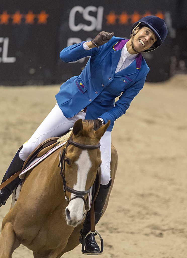 epa04555407 Portugal's Luciana Diniz rides Fit For Fun during the jump-off and cheers after winning the Longines Grand Prix at the equestrian show jumping CSI in Basel, Switzerland, 11 January 2015. EPA/GEORGIOS KEFALAS