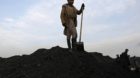 A labourer takes a break at a coal dump site outside Kabul January 19, 2015. Each labourer earns an average of $10 per workin