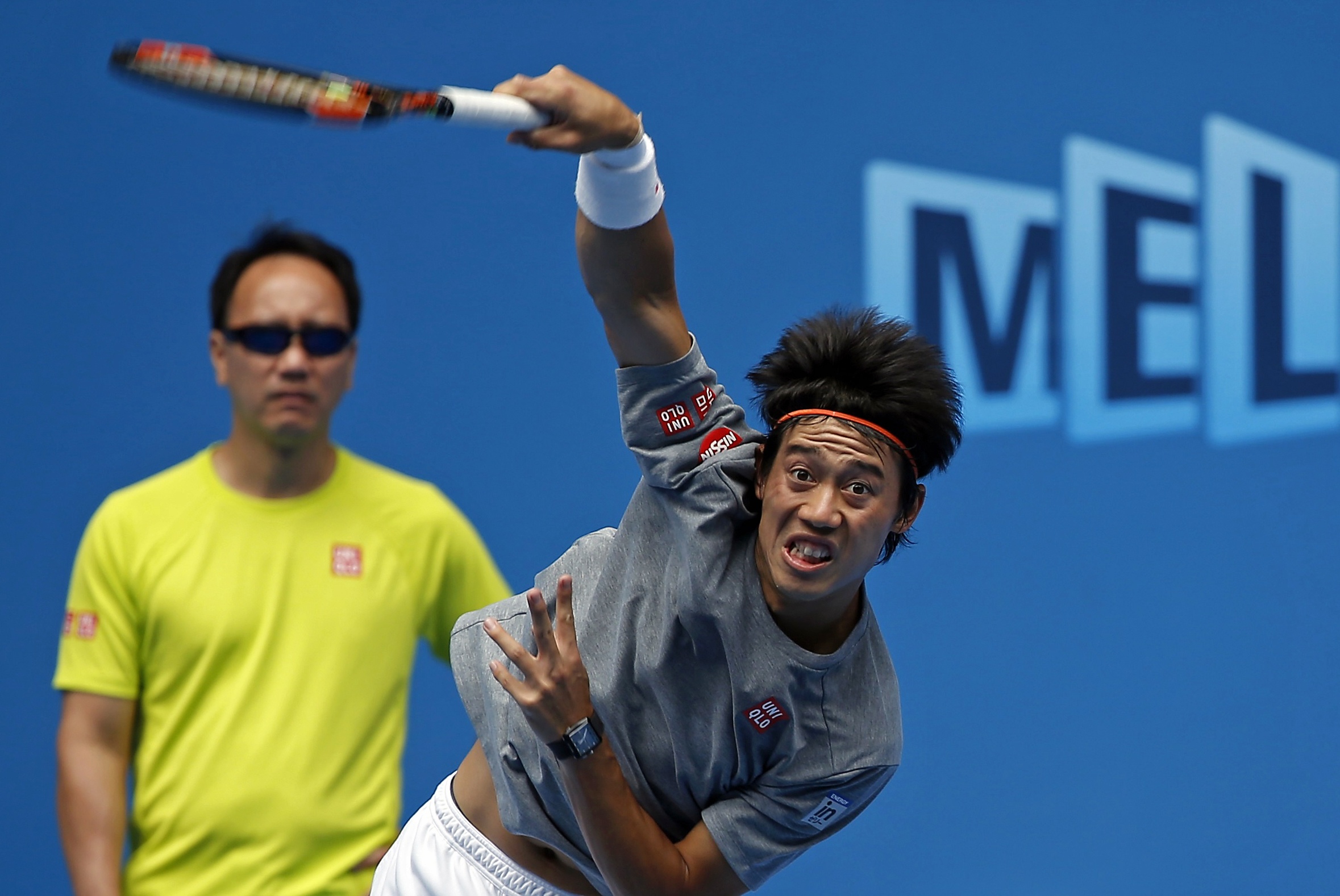 Japan's Kei Nishikori (R) hits a shot as his coach Michael Chang looks on during a training session at Hisense Arena at Melbourne Park January 18, 2015. The Australian Open tennis tournament begins on January 19. REUTERS/Issei Kato (AUSTRALIA - Tags: SPORT TENNIS)