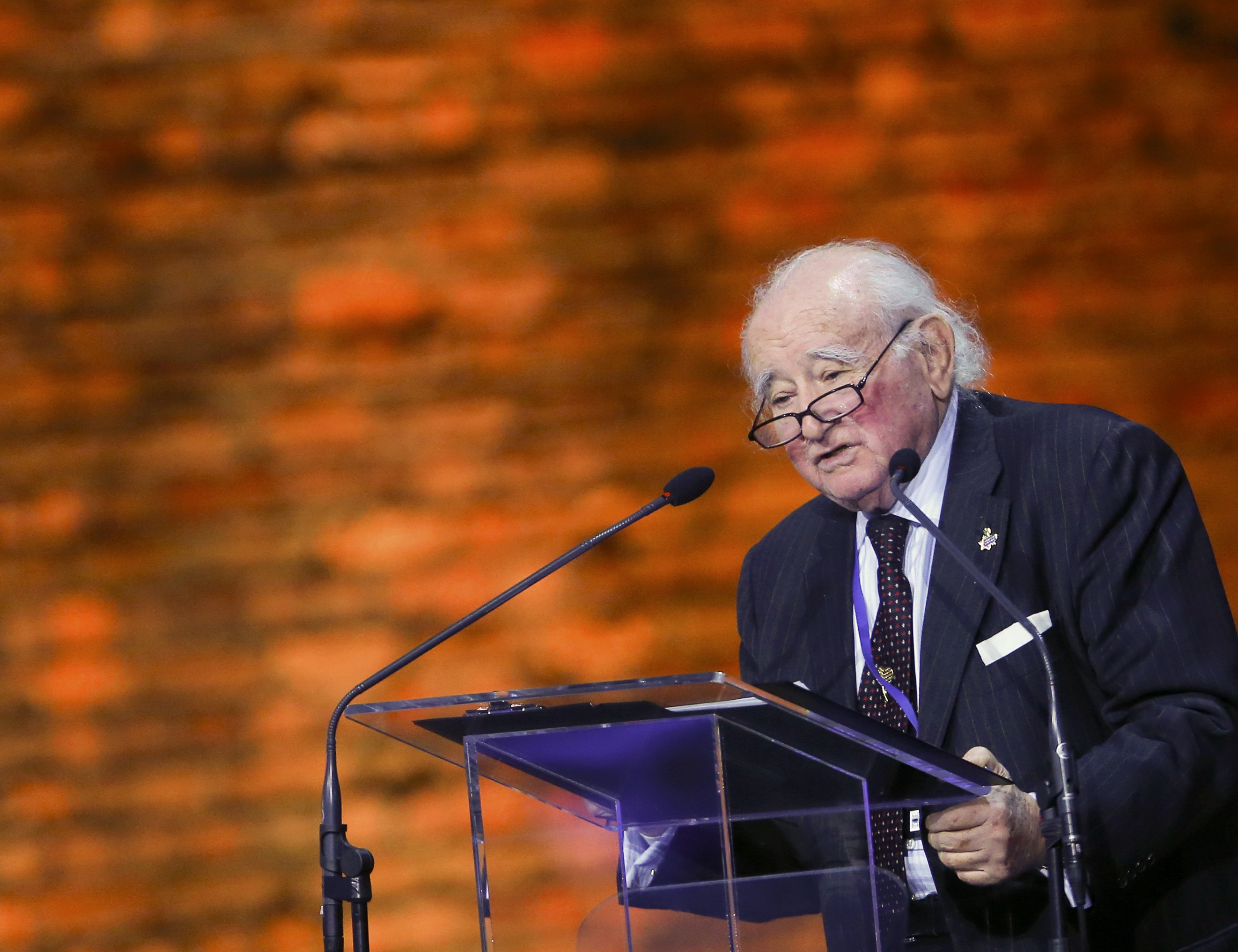 Survivor Roman Kent makes a speech at a ceremony on the site of the former Nazi German concentration and extermination camp Auschwitz-Birkenau near Oswiecim January 27, 2015. Ceremonies to mark the 70th anniversary of the liberation of the camp take place on January 27, with some 300 former Auschwitz prisoners taking part in the commemoration event. Nazi Germany built the Auschwitz camp in 1940 as a place of incarceration for the Poles. From 1942, it became the largest site of extermination of the Jews from Europe. In Auschwitz, Nazis killed at least 1.1 million people, mainly Jews, but also Poles, Roma, Soviet prisoners of war and prisoners of other ethnicities. On January 27, 1945 the camp was liberated by the Red Army soldiers. REUTERS/Laszlo Balogh (POLAND - Tags: ANNIVERSARY SOCIETY CONFLICT)
