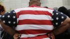 An overweight man wears a shirt patterned after the American flag during a visit to the World Trade Center, Thursday, May 8, 