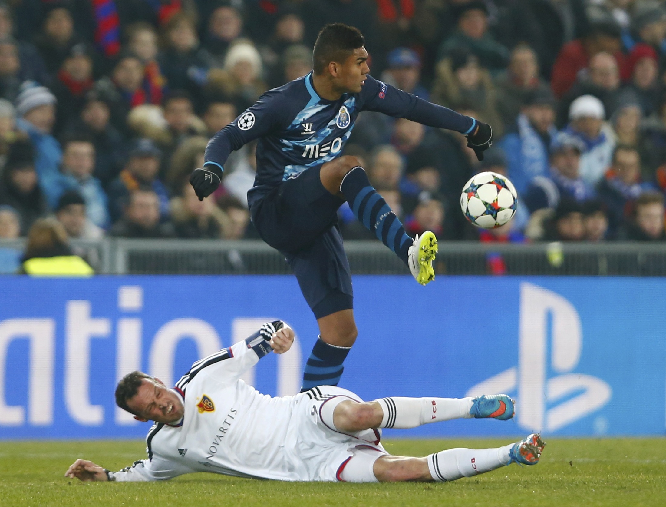 Porto's Casemiro (R) kicks the ball over FC Basel's Marco Streller during their Champions League round of 16 first leg soccer match in Basel, February 18, 2015. REUTERS/Arnd Wiegmann (SWITZERLAND - Tags: SOCCER SPORT)