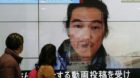 epa04598599 Passersby are watching an image of Kenji Goto pictured on last October with news reporting the Japanese hostage k