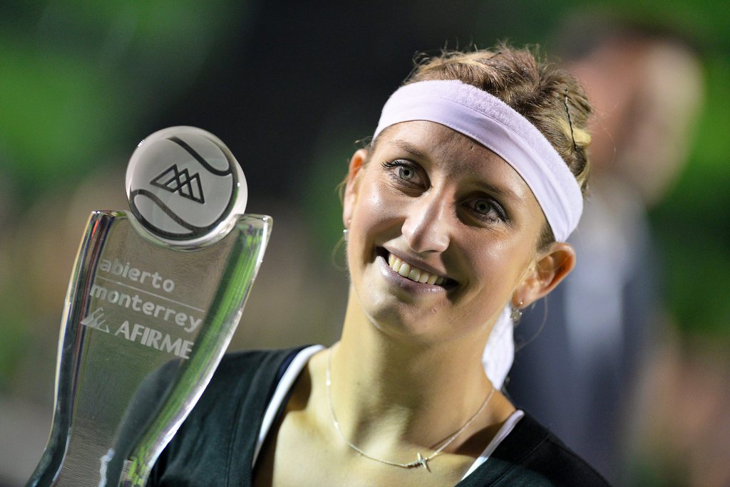 epa04654896 Swiss Timea Bacsinszky poses with her trophy after beating Caroline Garcia of France in their final match of the Monterrey Open tennis tournament in Monterrey, Mexico, 09 March 2015. The match ended nearly seven hours after they took to the court as it was suspended due to rain. EPA/MIGUEL SIERRA