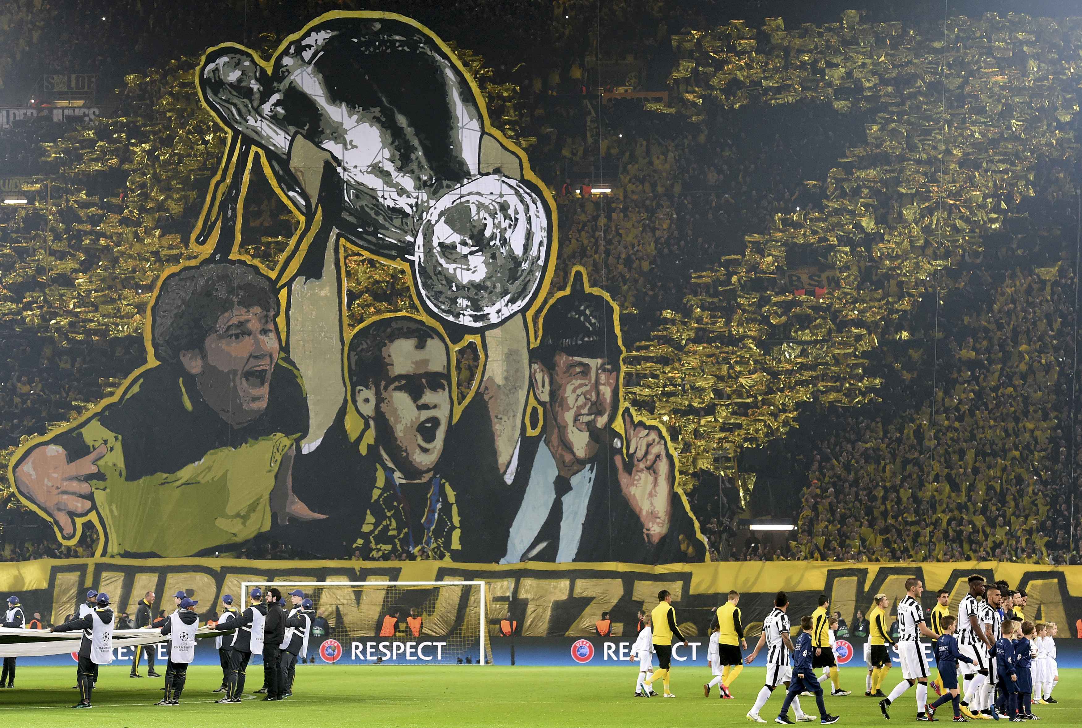 A giant banner depicting key players in Borussia Dormund's victory in the Champions League final against Juventus in 1997, is unfurled just before kick-off of the Champions League round of 16 second leg soccer match between Borussia Dortmund and Juventus in Dortmund March 18, 2015. Picture taken March 18. REUTERS/Fabian Bimmer