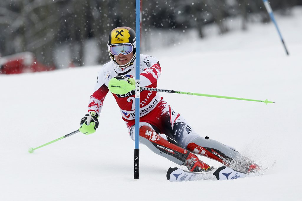 epa04674251 Marcel Hirscher of Austria clears a gate during the second run of the Men's Slalom race at the Alpine Skiing World Cup in Meribel, France, 22 March 2015. EPA/GUILLAUME HORCAJUELO