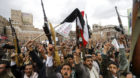 Shi'ite Muslim rebels hold up their weapons during a rally against air strikes in Sanaa March 26, 2015. Warplanes from Saudi 