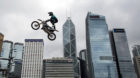 A rider performs in front of the city's skyline during the Red Bull X-fighters Jams freestyle show in Hong Kong April 4, 2015