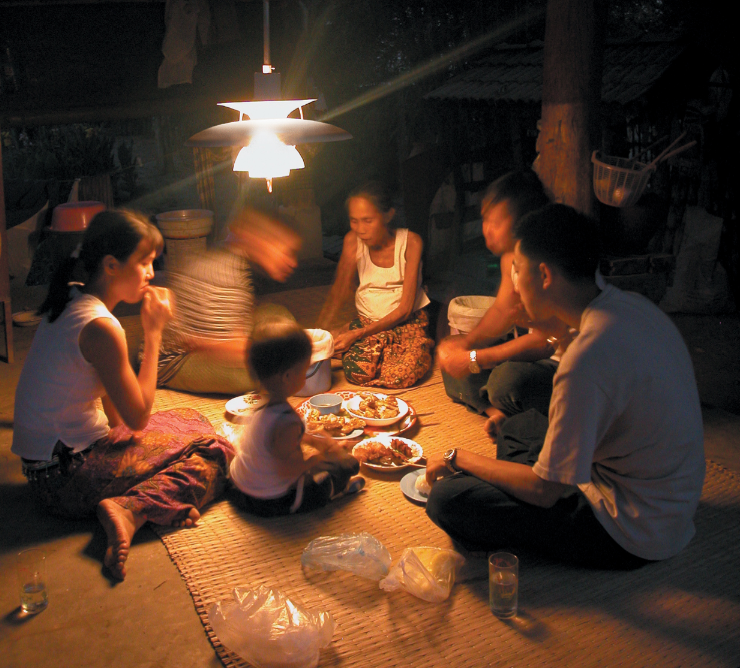 Eine thailändische Familie im Licht einer PH5-Biogaslampe von Superflex.
