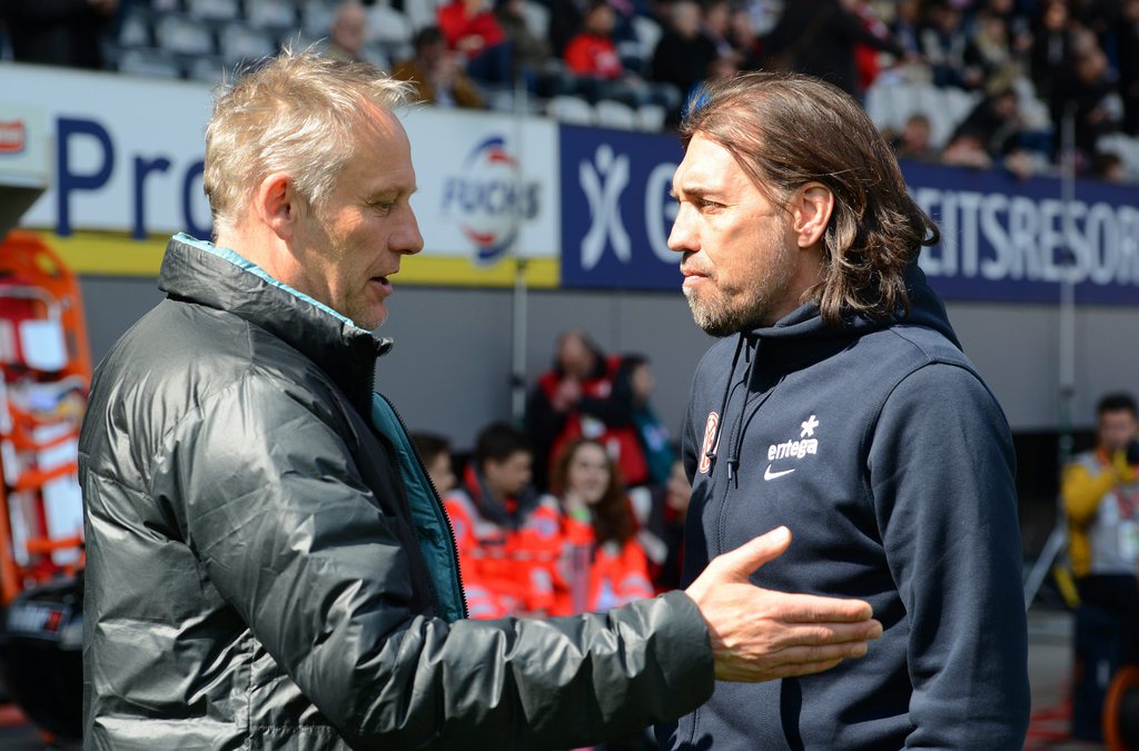 epa04710178 Freiburg's head coach Christian Streich (L) greets Mainz' head coach Martin Schmidt (R) before the German Bundesliga soccer match between SC Freiburg and FSV Mainz 05 in Freiburg, Germany, 18 April 2015. ....(EMBARGO CONDITIONS - ATTENTION: Due to the accreditation guidelines, the DFL only permits the publication and utilisation of up to 15 pictures per match on the internet and in online media during the match.) EPA/PATRICK SEEGER