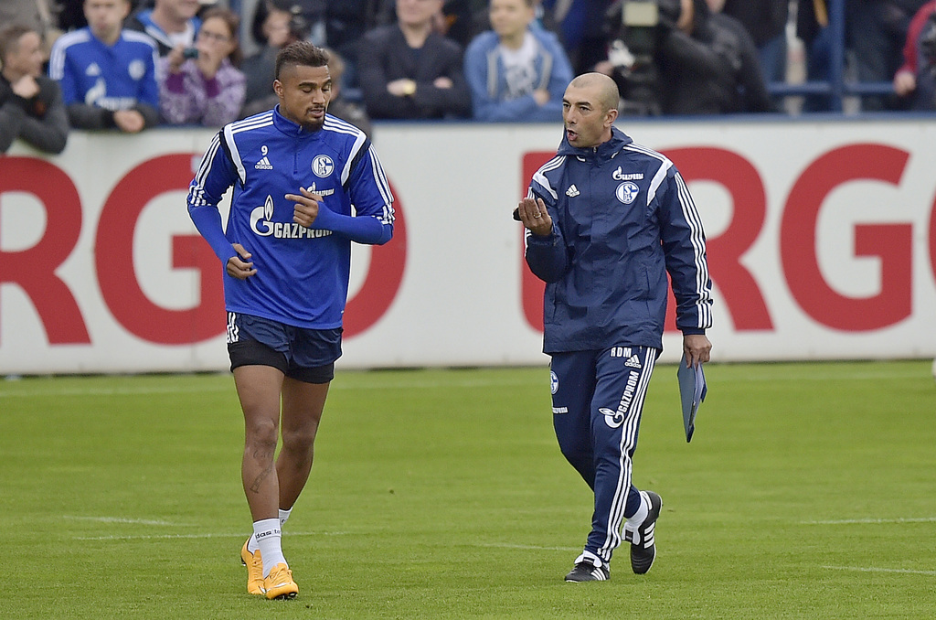 FILE - In this Oct. 9, 2014 file photo new head coach Roberto Di Matteo, right, advises player Kevin-Prince Boateng from Ghana at his first training session of Bundesliga soccer club FC Schalke 04 in Gelsenkirchen, Germany. Schalke says Monday, May 11, 2015, it is releasing midfielders Kevin-Prince Boateng and Sidney Sam with immediate effect. The move comes less than 24 hours after Schalke's 2-0 loss in Cologne that threatens Schalke's hopes of gaining a place in next season's Europa League. (AP Photo/Martin Meissner, File)