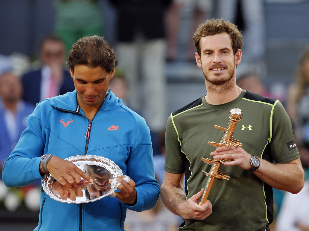 Andy Murray of Britain, right, holds the winners trophy as he poses with runner-up, Rafael Nadal of Spain, after their men's singles final match at the Madrid Open Tennis tournament in Madrid, Spain, Sunday, May 10, 2015. Murray defeated Rafael Nadal 6-3, 6-2. (AP Photo/Paul White) )
