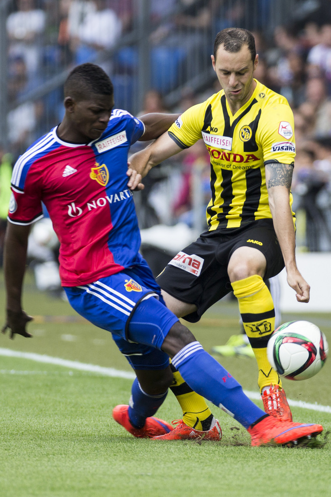 Basel's Breel Embolo, left, fights for the ball with Young Boys' Jan Lecjaks. right, during the Super League championship match FC Basel against BSC Young Boys at the St. Jakob-Park stadium in Basel, Switzerland, Sunday, May 17, 2015. (KEYSTONE/Patrick Straub)