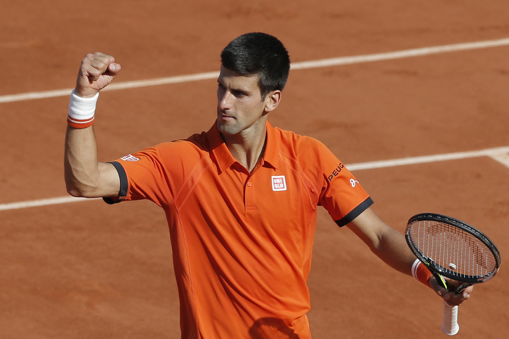 Serbia's Novak Djokovic celebrates winning the quarterfinal match of the French Open tennis tournament against Spain's Rafael Nadal in three sets, 7-5, 6-3, 6-1, at the Roland Garros stadium, in Paris, France, Wednesday, June 3, 2015. (AP Photo/Christophe Ena)