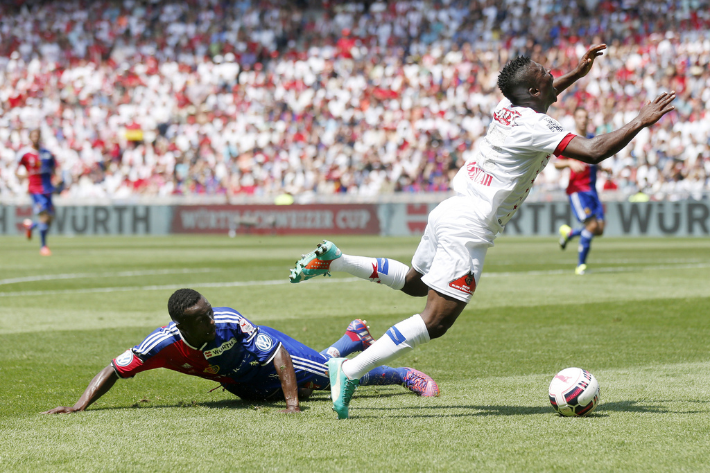 Basel's Adama Traore, left, fights for the ball with Sion's Ebenezer Assifuah, right, during the Swiss Cup final soccer match between FC Basel and FC Sion at the St. Jakob-Park stadium in Basel, Switzerland, Sunday, June 7, 2015. (KEYSTONE/Peter Klaunzer)