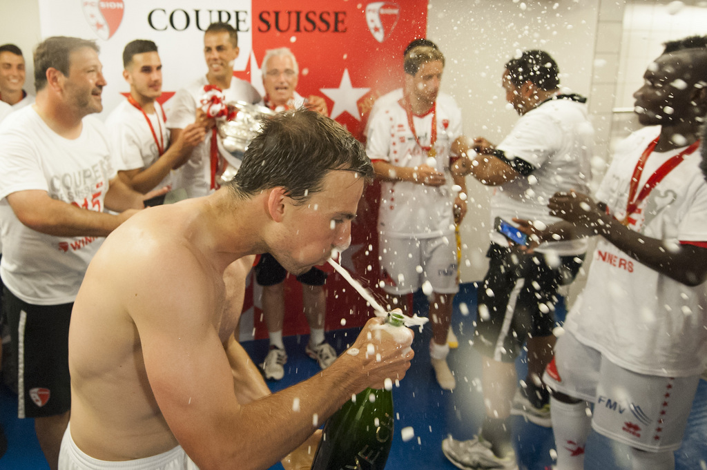 Sion's players celebrate with the trophy in the cloakroom during the Swiss Cup final soccer match between FC Basel and FC Sion at the St. Jakob-Park stadium in Basel, Switzerland, Sunday, June 7, 2015. (KEYSTONE/Jean-Christophe Bott)