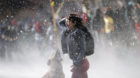 A protester reacts as police use water cannon during a demonstration to demand changes in the Chilean education system in San