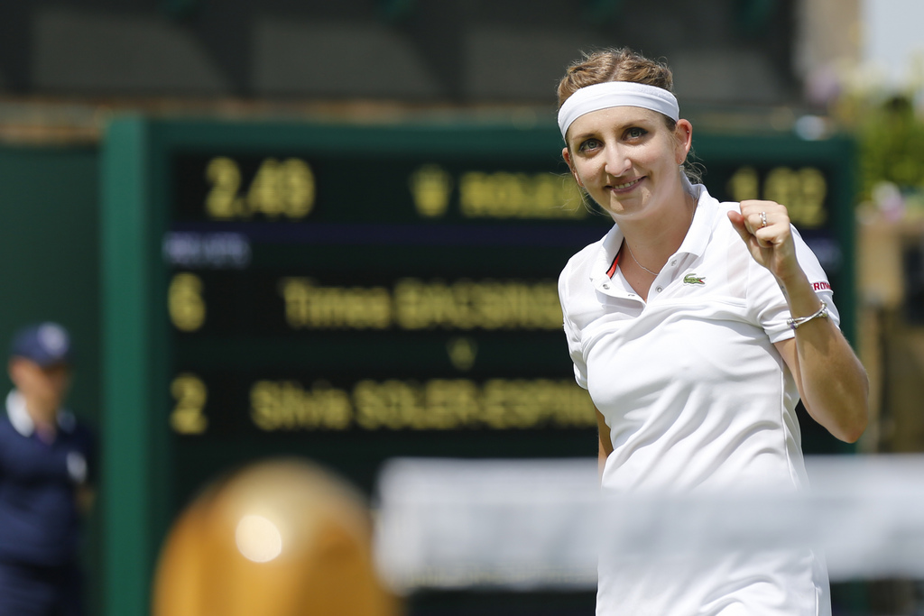 Timea Bacsinszky, of Switzerland, celebrates after beating Silvia Soler-Espinosa, of Spain, in her second round match at the All England Lawn Tennis Championships in Wimbledon, London, Thursday, July 2, 2015. (KEYSTONE/Peter Klaunzer) ***EDITORIAL USE ONLY, NO SALES, NO ARCHIVES ***