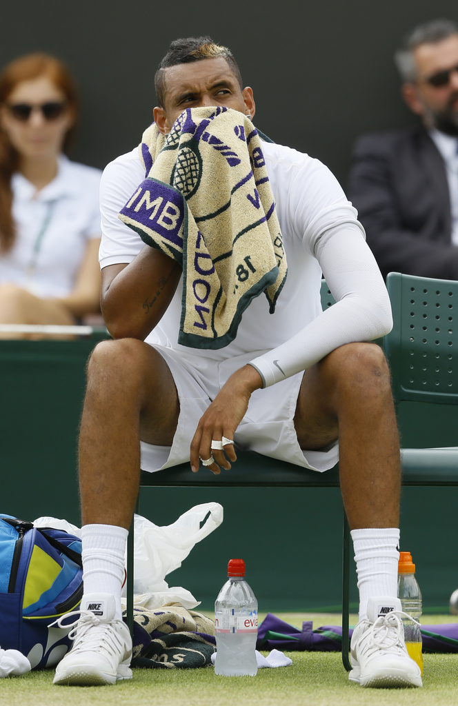 Nick Kyrgios of Australia wipes his face with a towel as he plays Richard Gasquet of France during their singles match at the All England Lawn Tennis Championships in Wimbledon, London, Monday July 6, 2015. (AP Photo/Kirsty Wigglesworth)