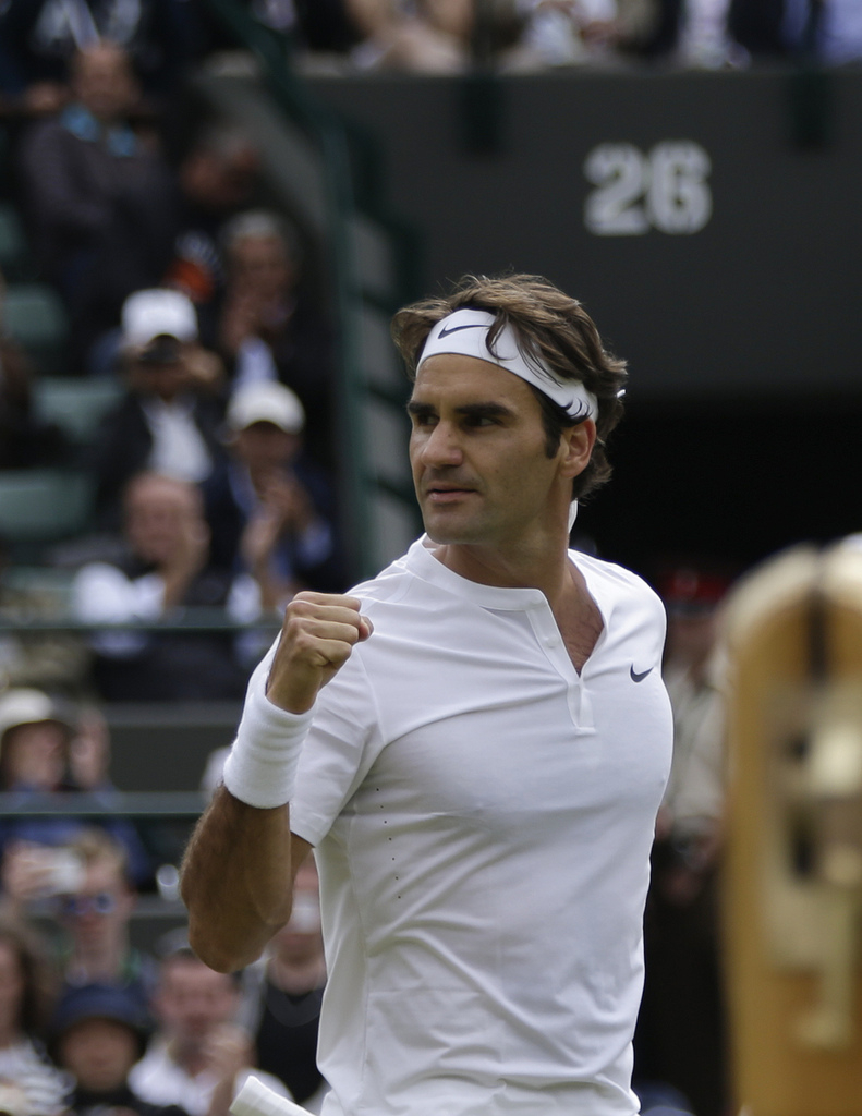 Roger Federer of Switzerland celebrates winning the singles match against Gilles Simon of France, at the All England Lawn Tennis Championships in Wimbledon, London, Wednesday July 8, 2015. Federer won 6-3, 7-5, 6-2. (AP Photo/Pavel Golovkin)