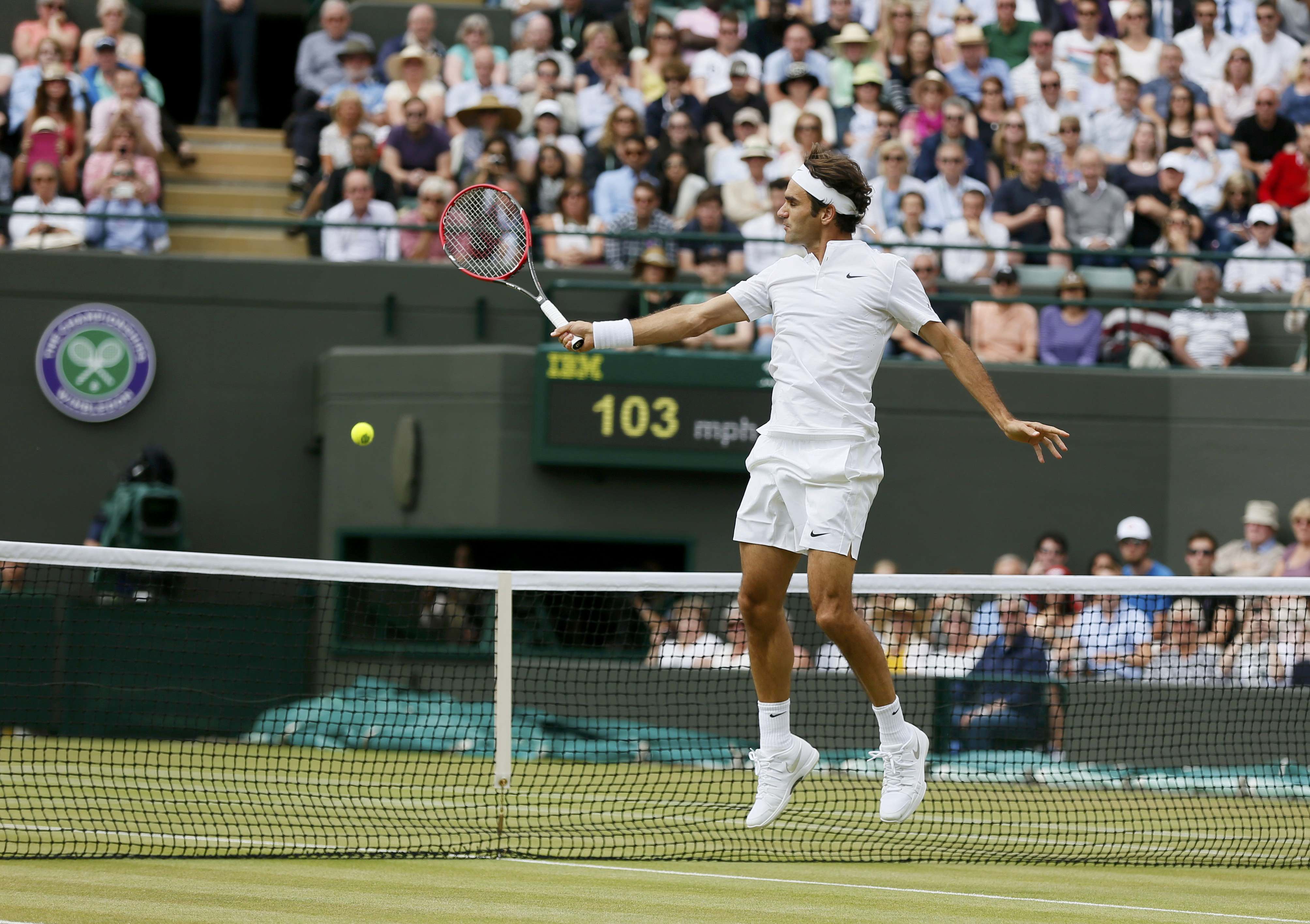Roger Federer of Switzerland hits the final shot to win his match against Gilles Simon of France at the Wimbledon Tennis Championships in London, July 8, 2015. REUTERS/Stefan Wermuth