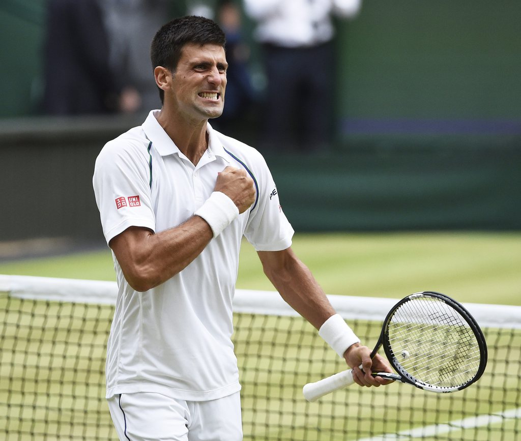 epa04844260 Novak Djokovic of Serbia celebrates his match point winner against Roger Federer of Switzerland in the men's final of the Wimbledon Championships at the All England Lawn Tennis Club, in London, Britain, 12 July 2015. EPA/FACUNDO ARRIZABALAGA EDITORIAL USE ONLY/NO COMMERCIAL SALES