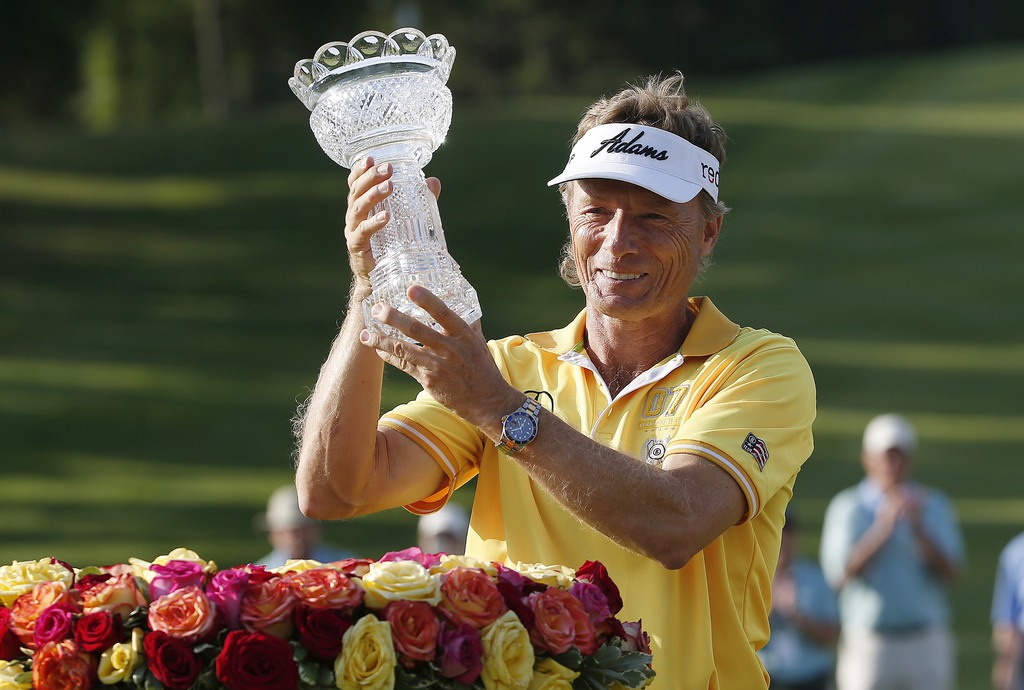 Bernhard Langer, of Germany, holds the trophy after winning the Senior Players Championship golf tournament in Belmont, Mass., Sunday, June 14, 2015. (AP Photo/Michael Dwyer)