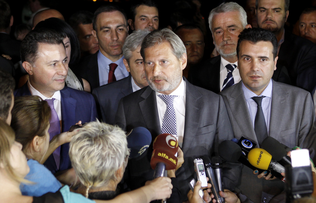 European Neighborhood Policy & Enlargement Negotiations commissioner Johannes Hahn, center, talks to the media in presence of the four most relevant party leaders in Macedonia, Prime Minister and leader of the VMRO-DPMNE conservative party Nikola Gruevski, left, the leader of the Democratic Union for Integrations Ali Ahmeti, center rear, the leader of Macedonian opposition Social Democrats Zoran Zaev, right and the leader of the Democratic Party of the Albanians Menduh Thaci, second from right, after their talks in Skopje, Macedonia, early Wednesday, July 15, 2015. (AP Photo/Boris Grdanoski)
