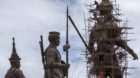 Labourers work on the giant bronze statue of former King Ram Khamhaeng (R) at Ratchapakdi Park in Hua Hin, Prachuap Khiri Kha