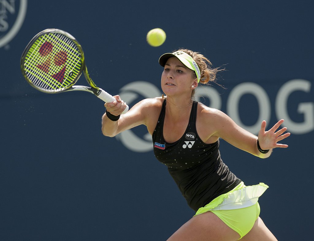epa04886736 Switzerland's Belinda Bencic in action against Romania's Simona Halep in the final match at the Rogers Cup women's tennis tournament in Toronto, Canada, 16 August 2015. Bencic defeated Halep 7-6(5), 6(4)-7, 3-0 after Halep retired partway through the third set. EPA/WARREN TODA