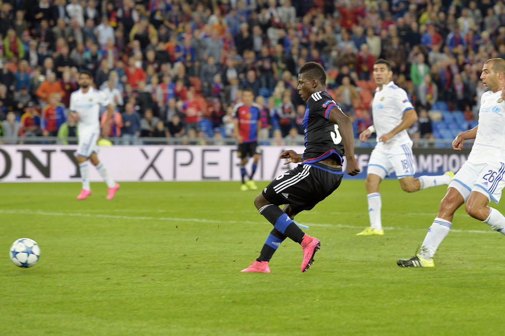 Basel's Breel Embolo, left, scores the second goal for Basel during the UEFA Champions League play-off round first leg soccer match between Switzerland's FC Basel 1893 and Israel's Maccabi Tel Aviv FC in the St. Jakob-Park stadium in Basel, Switzerland, on Wednesday, August 19, 2015. (KEYSTONE/Walter Bieri )