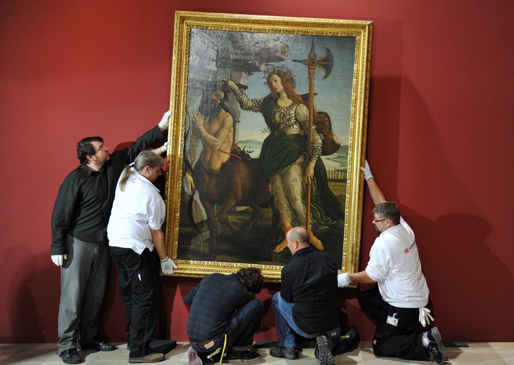 epa01922659 The painting 'Minerva and the Centaur' by Italian artist Sandro Boticelli (around 1445-1510) is prepared for hanging at Staedel museum in Frankfurt am Main, Germany, 05 November 2009. The painting is on loan from Uffizi gallery in Florence, Italy for the first monographic exhibition on Boticelli in Germany. Many works of the Italian master will be displayed from 13 November to 28 February 2010. EPA/ARNE DEDERT