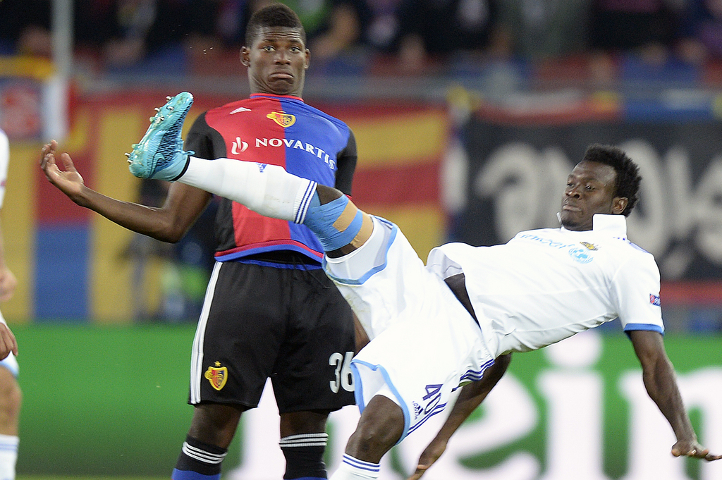 Maccabi's Nosakhare Igiebor, right, fights against Basel's Breel Embolo, left, during the UEFA Champions League play-off round first leg soccer match between Switzerland's FC Basel 1893 and Israel's Maccabi Tel Aviv FC in the St. Jakob-Park stadium in Basel, Switzerland, on Wednesday, August 19, 2015. ( )