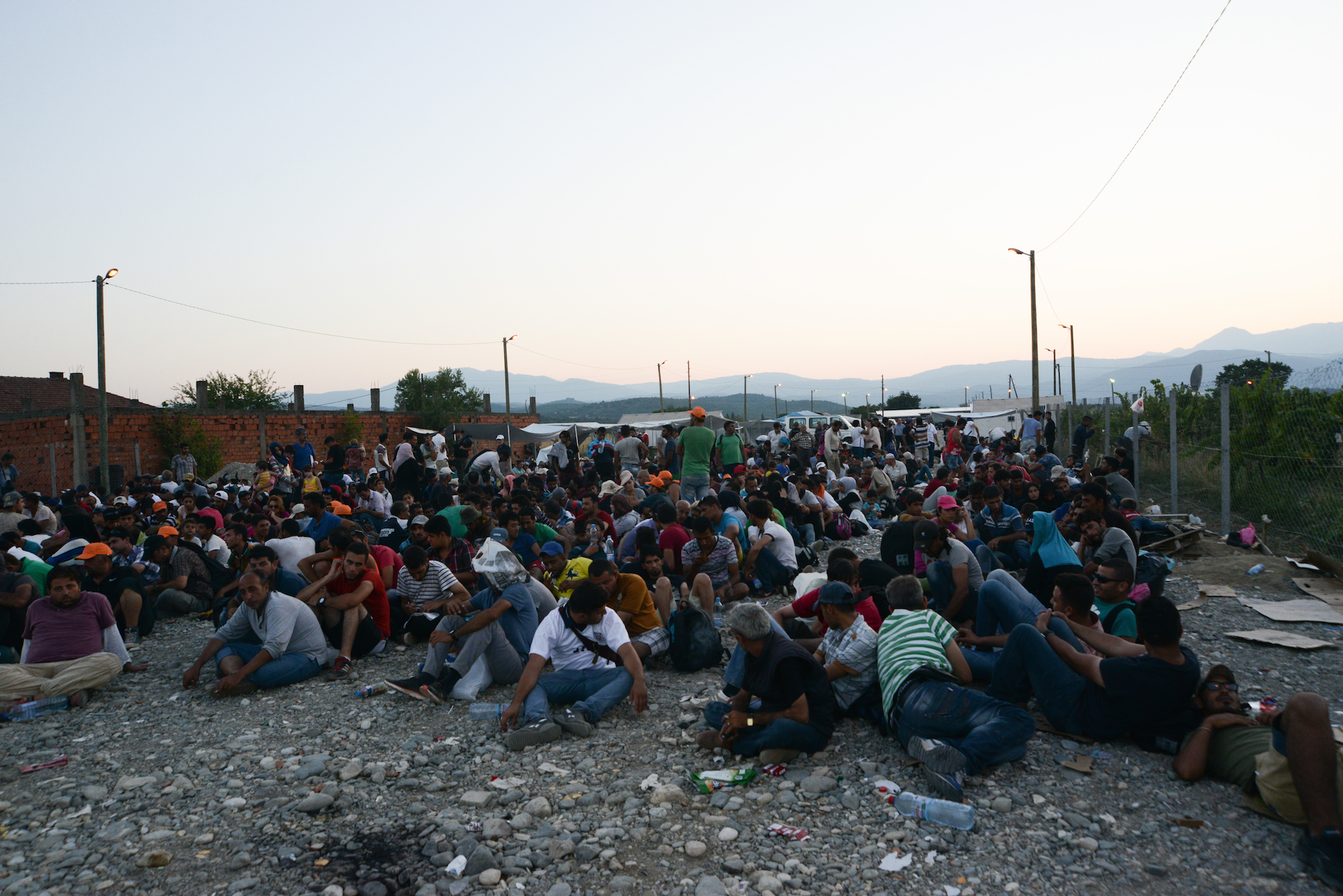 Refugees at the Greek / FYR of Macedonia border on August 31. 2015. On a daily basis thousands of refugees pass the border to get a train, bus or taxi to Serbia