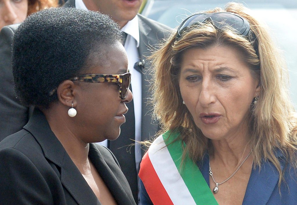 epa03898915 Italy's minister for Integration Cecile Kyenge (L) walks with Lampedusa's Mayor Giusi Nicolini (R), outside the reception center on the Lampedusa Island, southern Italy, 06 October 2013. The 155 migrants who survived the sinking of their boat off the Italian island of Lampedusa on 03 October could face illegal immigration charges, the Ansa news agency reported 05 October, citing prosecutors. At least 111 people died when the overcrowded boat caught fire and sank early Thursday. Hundreds more are believed to be missing. The incident has once again focused attention on the problem of African and Middle Eastern immigrants trying to reach Europe under unsafe conditions. EPA/ETTORE FERRARI