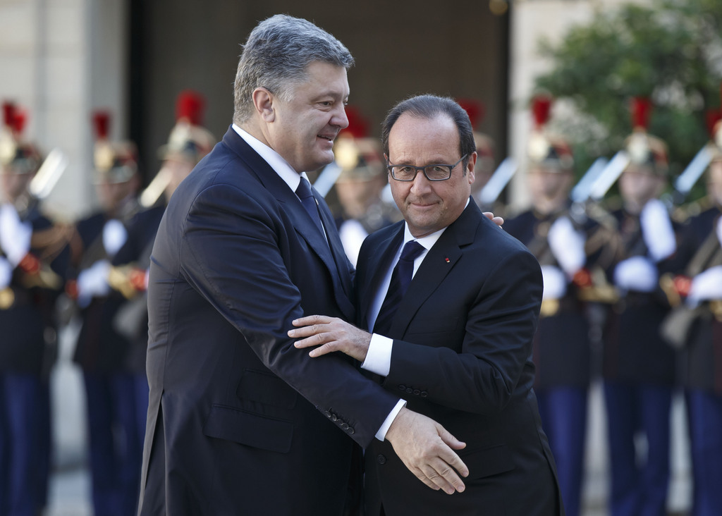 Ukrainian President Petro Poroshenko, left, is welcomed by French President Francois Hollande at the Elysee Palace in Paris, France, Friday, Oct. 2, 2015. Ukrainian President Petro Poroshenko arrived in Paris on Friday for talks with German Chancellor Angela Merkel, French President Francois Hollande and Russian President Vladimir Putin for the first time since they worked out a peace deal in Minsk in February. The long-awaited summit in Paris on Friday is being overshadowed by international concerns about Russia�s military intervention in Syria this week. (AP Photo/Michel Euler)