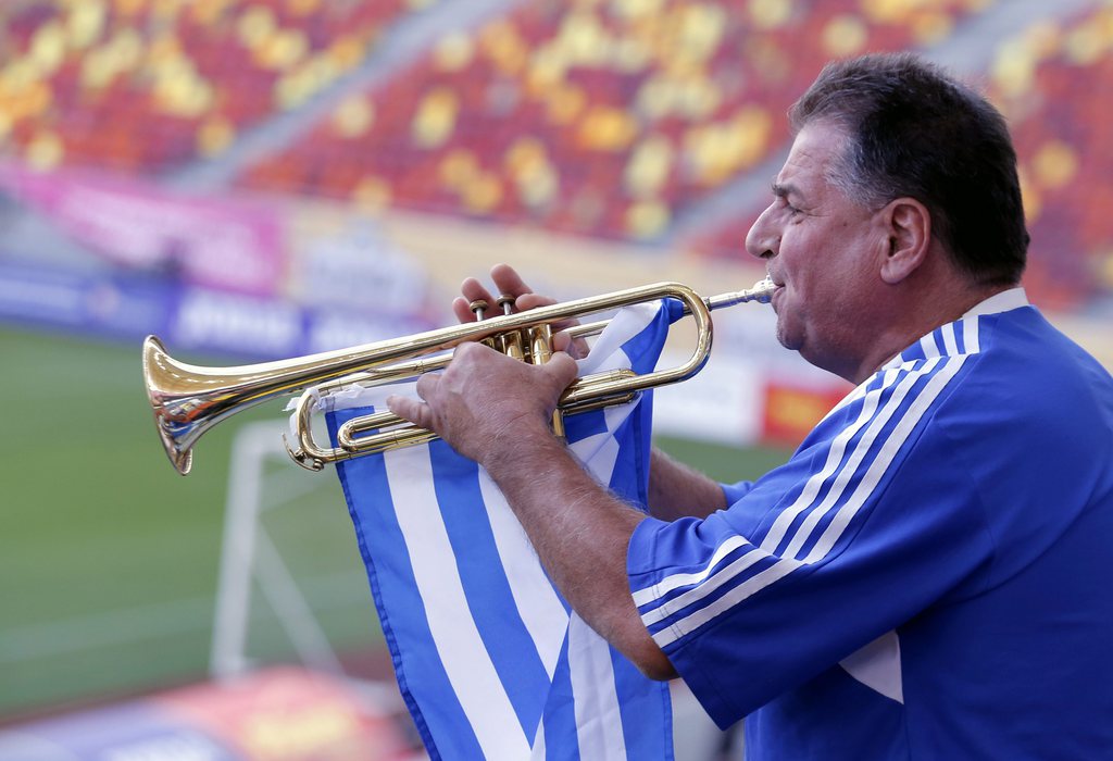 epa04916935 A supporter of the Greek national soccer team plays the trumpet during their training session held at the National Arena in Bucharest, Romania, 06 September 2015, one day before the Romania vs Greece UEFA Euro 2016 qualifying Group F soccer match. EPA/ROBERT GHEMENT
