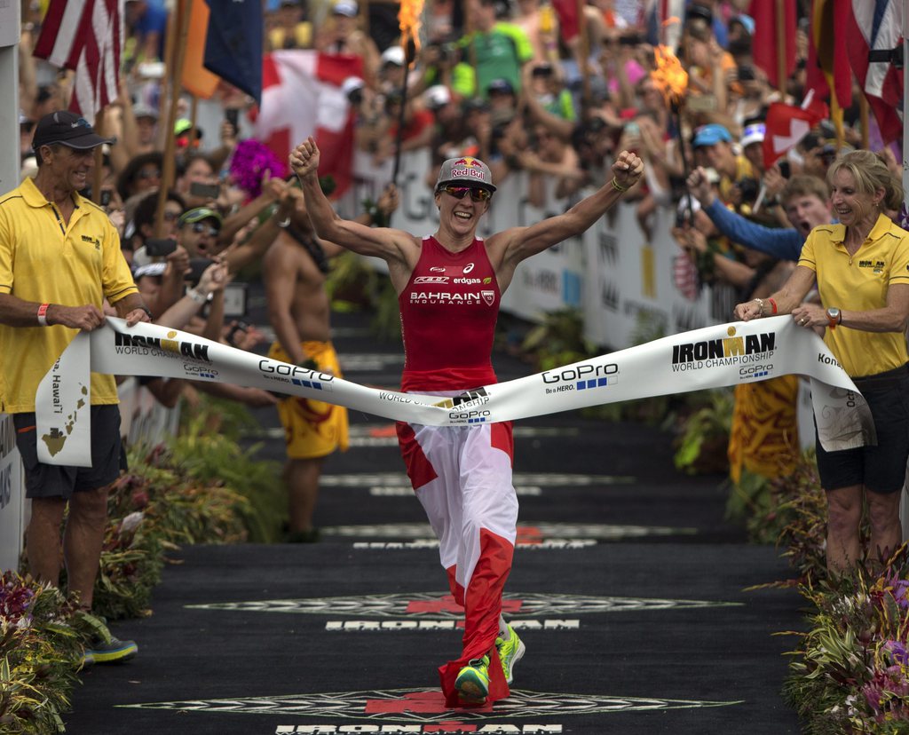 epa04972756 Daniela Ryf of Switzerland crosses the finish line with a time of 8 hours, 57 minutes and 57 seconds, to win the women's division in the 2015 Ironman World Championship in Kailua-Kona, Hawaii, USA, 10 October 2015. The culmination of a series of International Ironman races, on the World championship course the athletes compete in a 3.85 km swim then a 180 km bike ride to finish it off with a 42.195 km Marathon run. EPA/BRUCE OMORI
