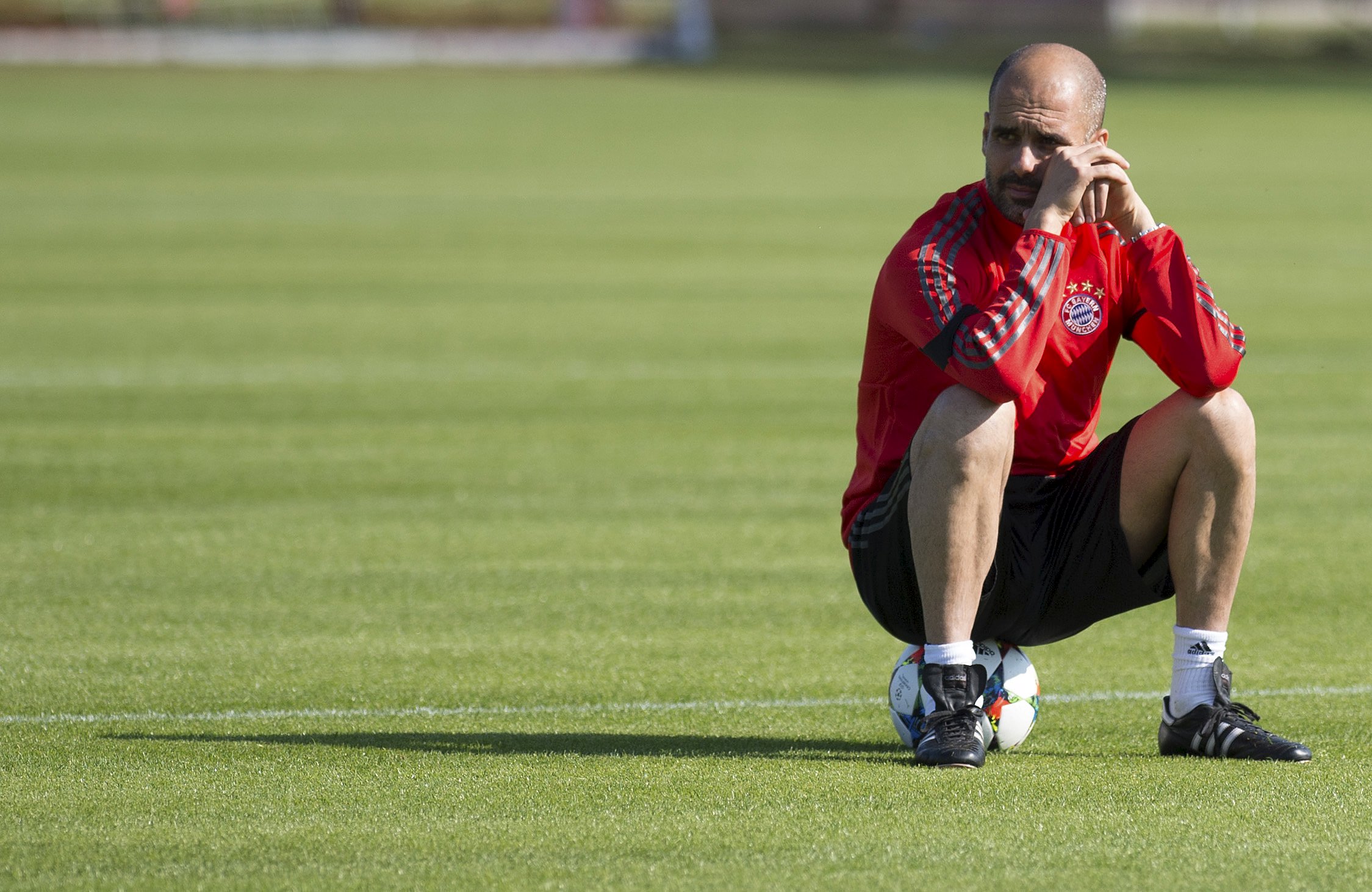 Bayern Munich's coach Pep Guardiola pauses during a training session at the club's training ground in Munich April 20, 2015. Bayern Munich will play their Champions League quarter-final second leg soccer match against Porto on Tuesday. REUTERS/Lukas Barth