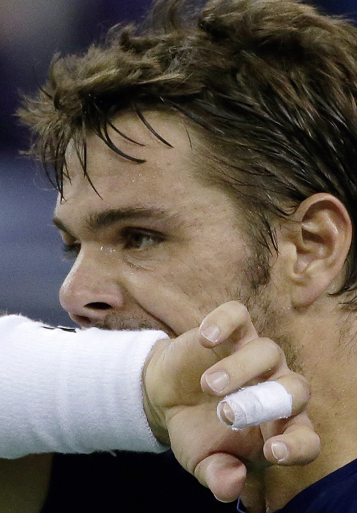 Stan Wawrinka of Switzerland wipes his sweat while playing against Rafael Nadal of Spain during their quarterfinal match of the Shanghai Masters tennis tournament in Shanghai, China, Friday, Oct. 16, 2015. (AP Photo/Andy Wong)