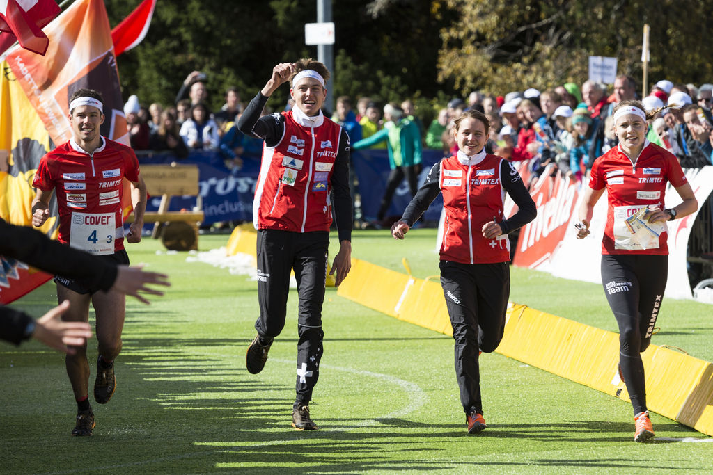Martin Hubmann, Matthias Kyburz, Rahel Friederich, and Sara Luescher of Switzerland, from left, approach the finish line to win todays sprint orienteering world cup competition, on Sunday, October 4, 2015, in Arosa, canton of Grisons, Switzerland. (KEYSTONE/Gian Ehrenzeller)