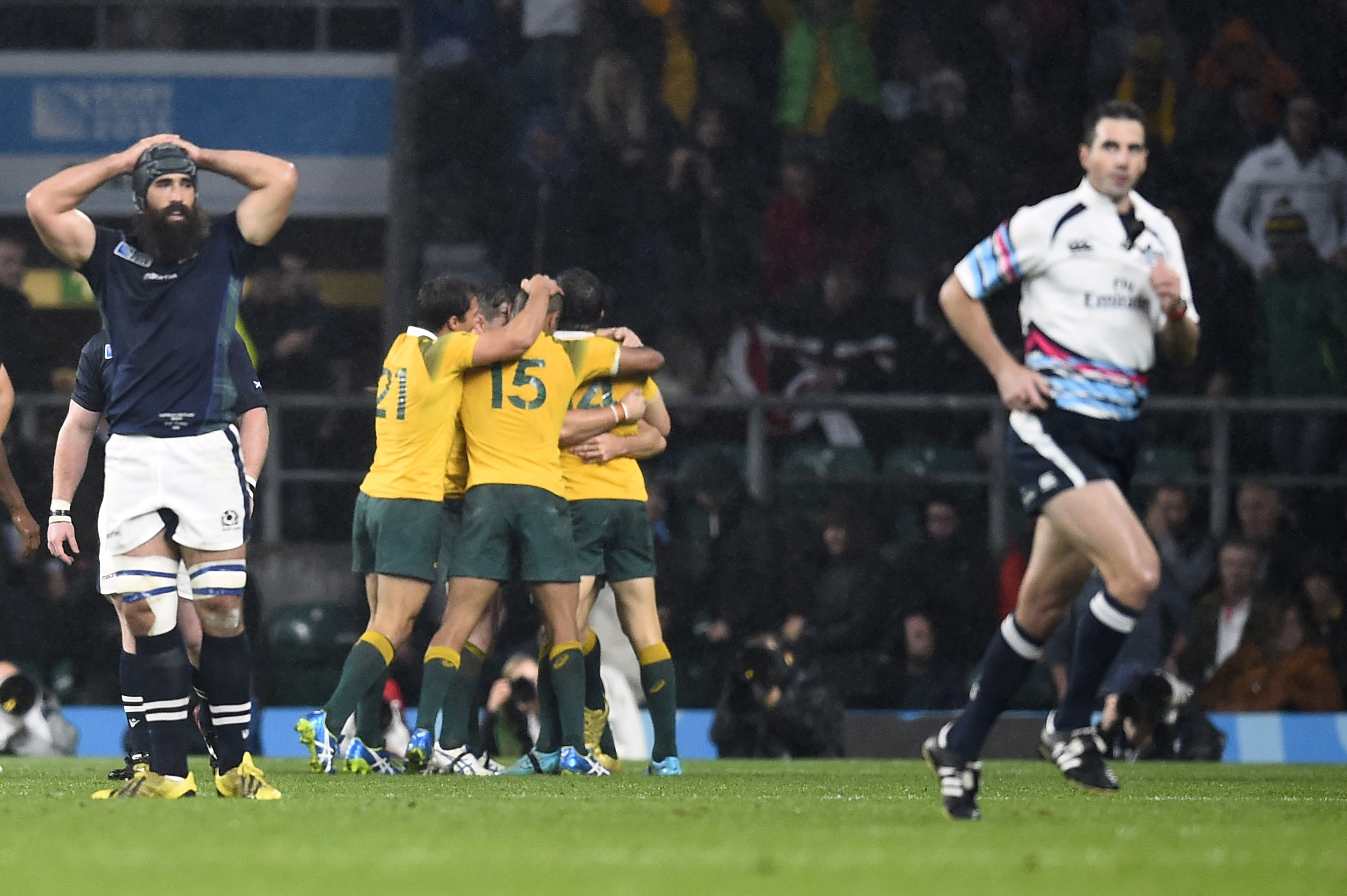 Rugby Union - Australia v Scotland - IRB Rugby World Cup 2015 Quarter Final - Twickenham Stadium, London, England - 18/10/15 Australia players celebrate their win as Referee Craig Joubert (R) leaves the field at the end of the game Reuters / Dylan Martinez Livepic