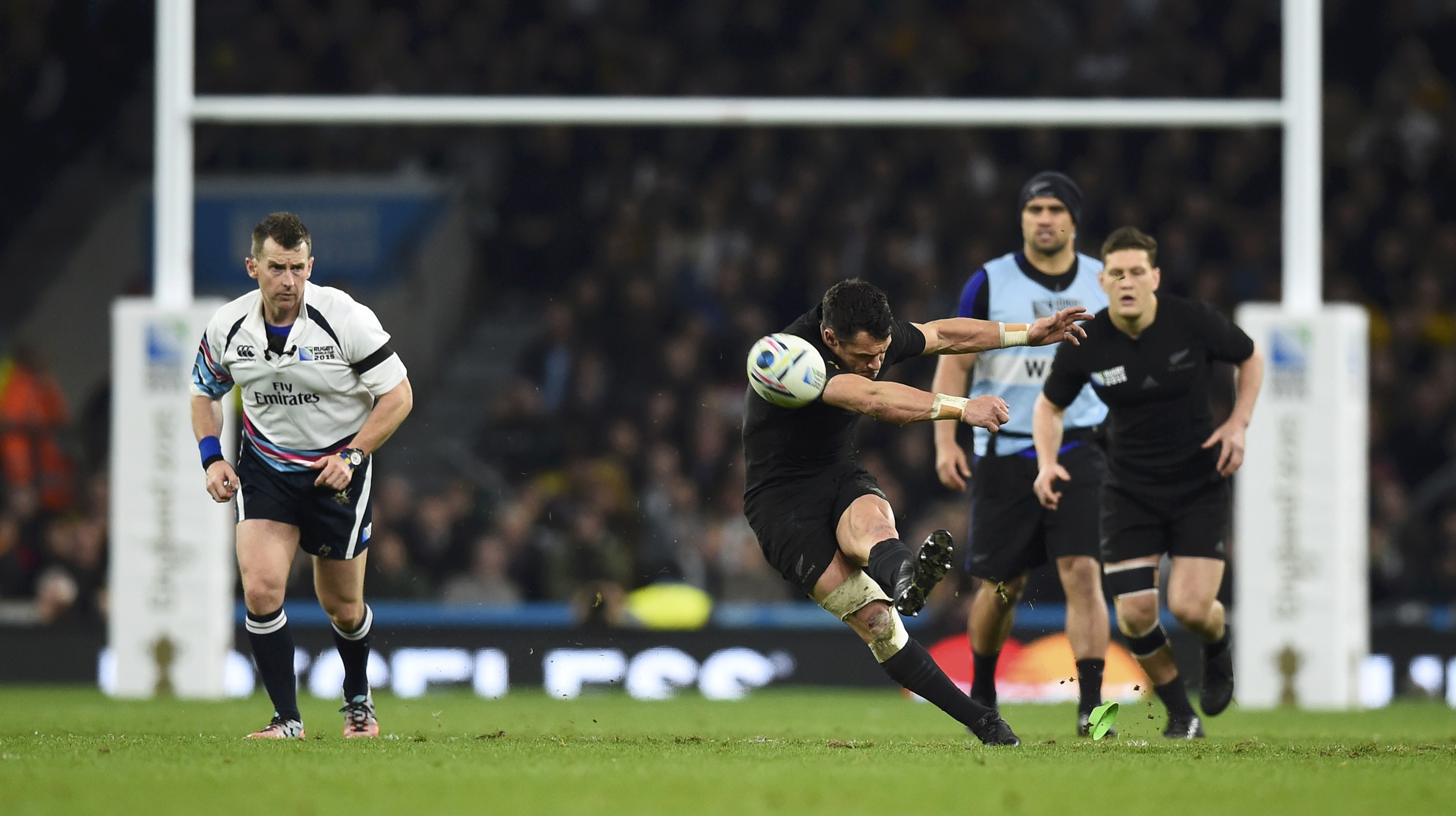Dan Carter of New Zealand (R) kicks the ball during their Rugby World Cup final match against Australia at Twickenham in London, Britain, October 31, 2015. REUTERS/Dylan Martinez