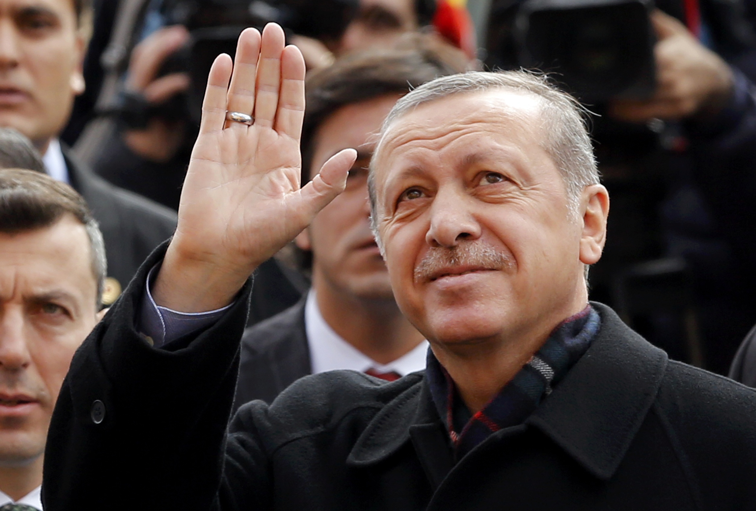 Turkish President Tayyip Erdogan greets his supporters as he leaves from a polling station in Istanbul, Turkey November 1, 2015. Turks began voting on Sunday amid worsening security and economic worries in a snap parliamentary election that could profoundly impact the divided country's trajectory and that of President Tayyip Erdogan. The parliamentary poll is the second in five months, after the ruling AK Party founded by Erdogan failed to retain its single-party majority in June. REUTERS/Murad Sezer TPX IMAGES OF THE DAY