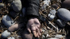 ATTENTION EDITORS - VISUAL COVERAGE OF SCENES OF INJURY OR DEATH  The hand of a drowned migrant man lies at a beach after bei