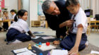 U.S. President Barack Obama learns a girl's name as he greets students on a tour of the Dignity for Children Foundation, an e