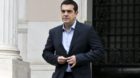Greek Prime Minister Alexis Tsipras leaves his office in Maximos Mansion after a meeting with his government's financial staf