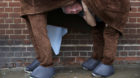 A participant peeks from his costume before the start of the the annual London Pantomime Horse Race in Greenwich, Britain Dec