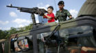 Children play in a military vehicle during the Children's Day celebration in Bangkok, Thailand January 9, 2016. Army barracks