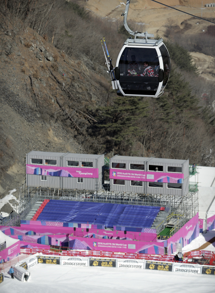 Austrian skiers ride in the gondola above the grandstand during a free skiing session following the cancellation of the first training run for a test event of the Pyeongchang 2018 Winter Olympics at the Jeongseon Alpine Centre in Jeongseon, South Korea, Wednesday, Feb. 3, 2016. The World Cup downhill and super-G races Saturday and Sunday are the first of 28 official test events for the next Winter Games. (AP Photo/Mark Schiefelbein)